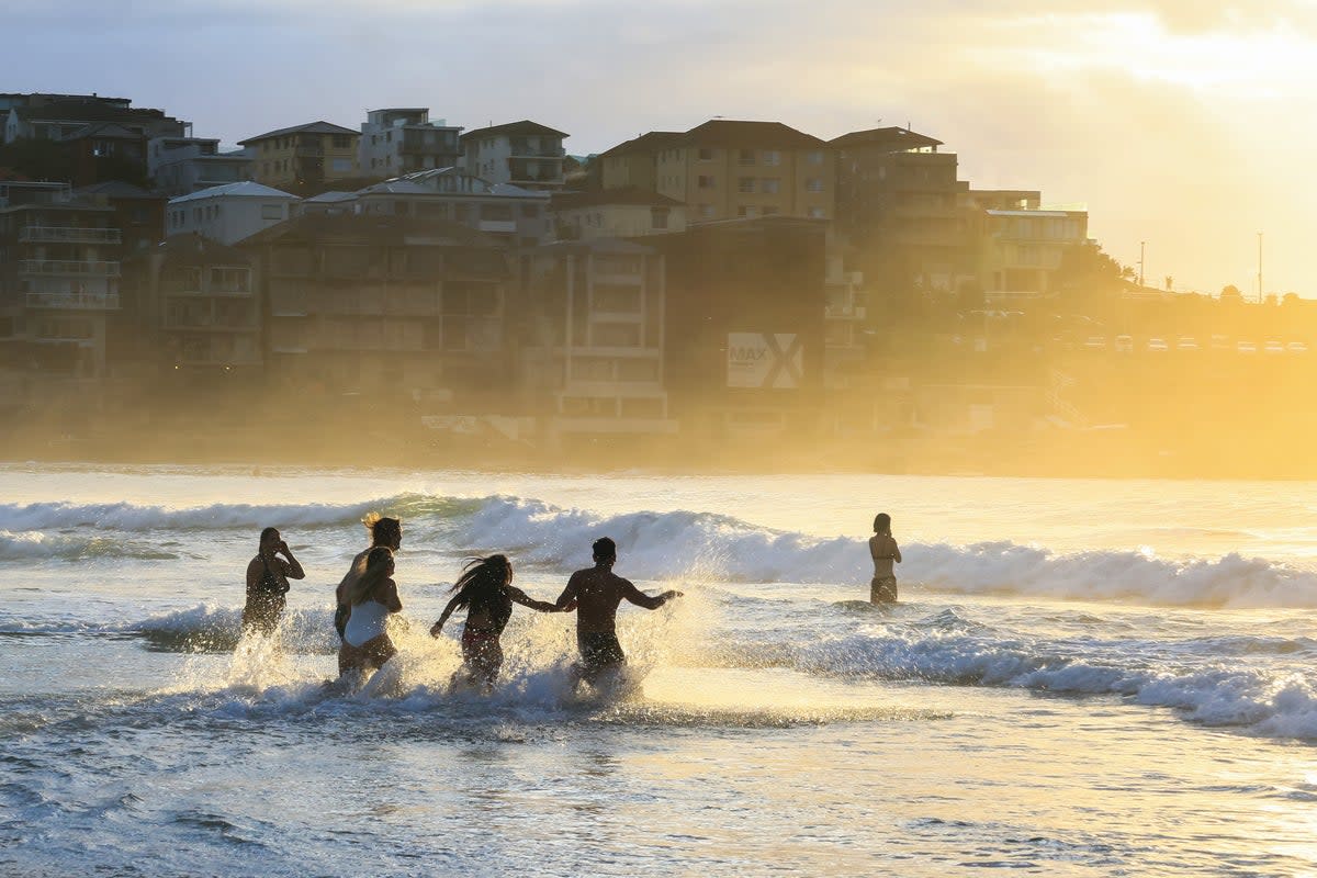 Representative: People run into the water at an Australian beach (Getty Images)