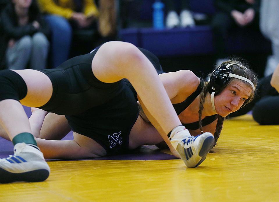 Ames' Alexis Winkey goes for a pinned Norwalk's Madelyn Carroll during their 125-pound wresting in the Central Iowa Kickoff Girls Wrestling Tournament at Nevada High School on Saturday, Nov. 18, 2023, in Nevada, Iowa.