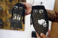 Iraqi artist Akeel Khreef displays some of his art works depicting jihadists on the soles of worn-out shoes on January 13, 2015 in Baghdad