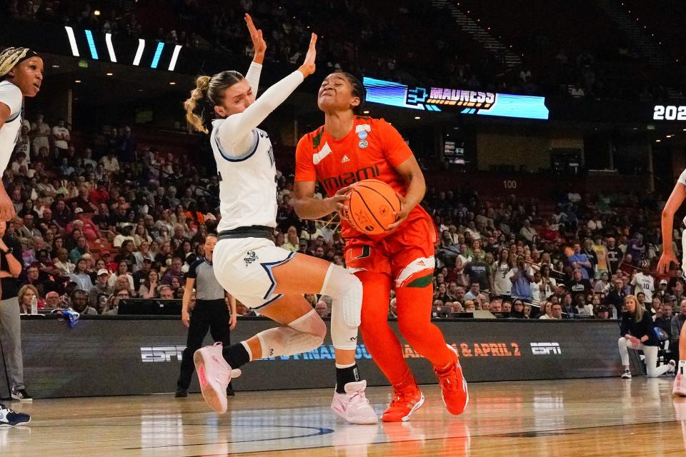 Miami forward Destiny Harden drives to the basket against Villanova guard Bella Runyan.