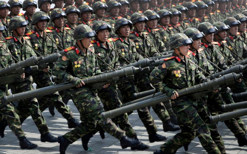 Soldiers carrying rockets march across Kim Il Sung Square during a military parade to celebrate the 105th birth anniversary of Kim Il Sung in Pyongyang - Credit: AP