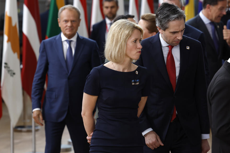 Estonia's Prime Minister Kaja Kallas, center, walks with Ireland's Prime Minister Simon Harris, center right, prior to a group photo at an EU summit in Brussels, Thursday, June 27, 2024. European Union leaders are expected on Thursday to discuss the next EU top jobs, as well as the situation in the Middle East and Ukraine, security and defence and EU competitiveness. (AP Photo/Geert Vanden Wijngaert)