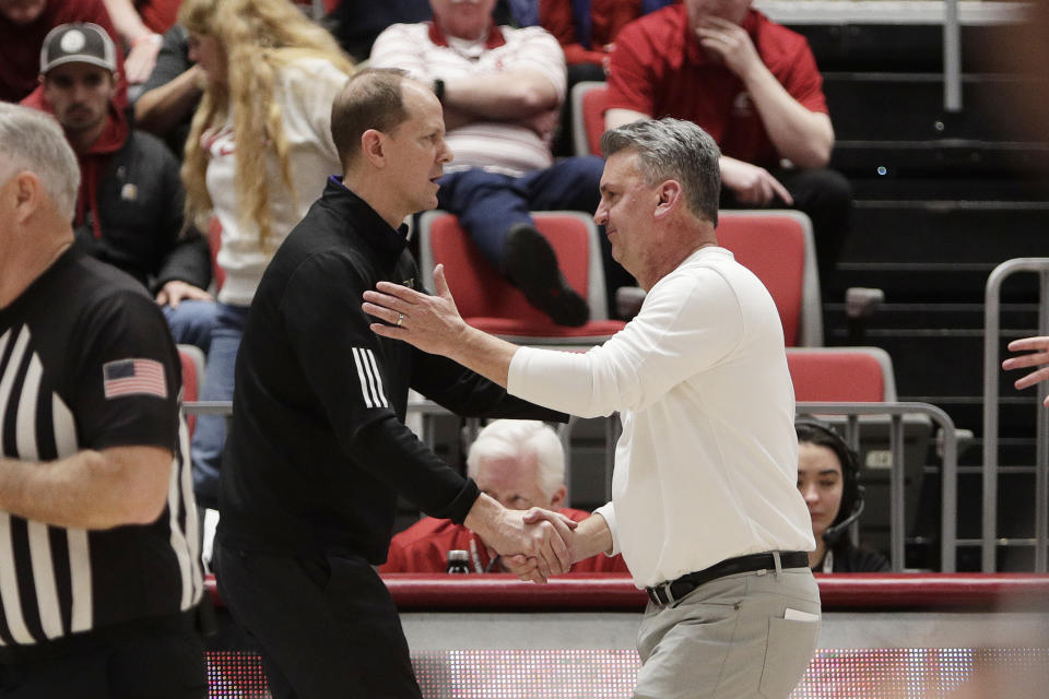 Washington head coach Mike Hopkins, center left, and Washington State head coach Kyle Smith, center right, greet each other after an NCAA college basketball game, Thursday, March 7, 2024, in Pullman, Wash. (AP Photo/Young Kwak)