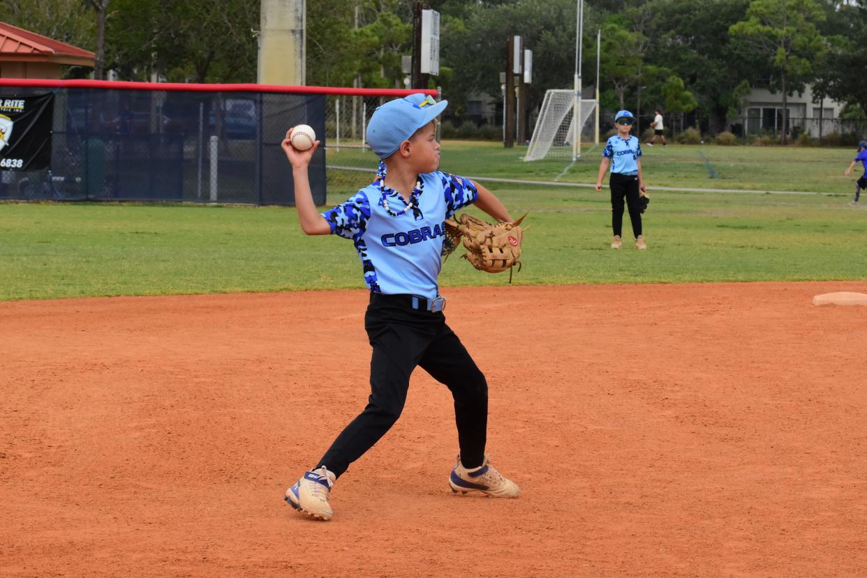 West Boynton Travel Cobras player Easton Dangler throws to first base for the out during an 8U travel game on April 28, 2024.