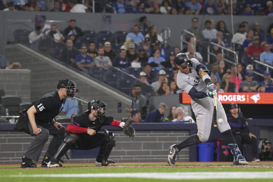 New York Yankees' Aaron Judge hits a two-run single in front of Toronto Blue Jays catcher Danny Jansen during the ninth inning of a baseball game Friday, June 28, 2024, in Toronto. (Chris Young/The Canadian Press via AP)