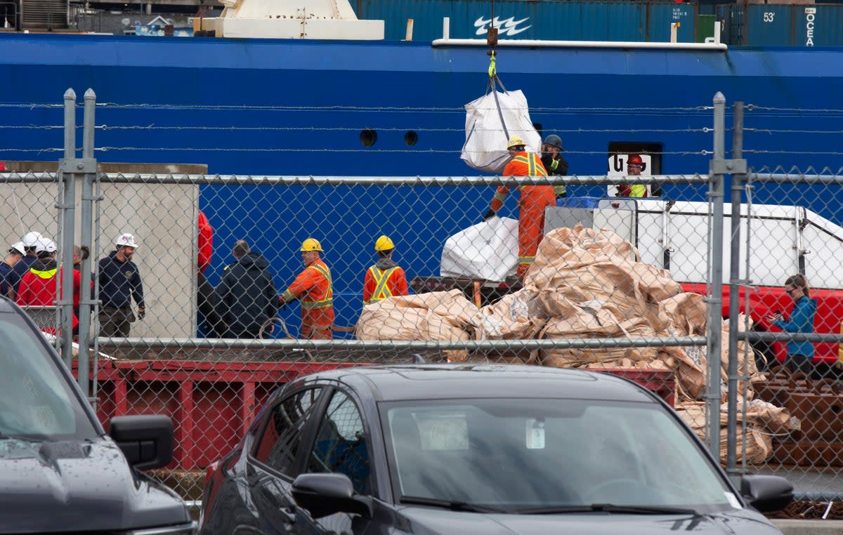 Debris from the Titan submersible, recovered from the ocean floor near the wreck of the Titanic, is unloaded