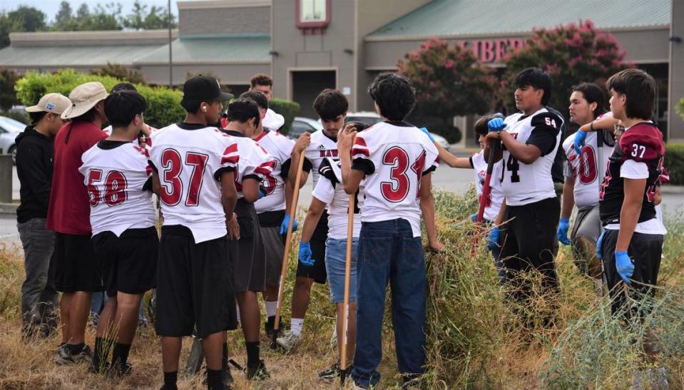 The Delhi High School football players wore their jerseys while participating in a community cleanup on Saturday, Sept. 9, 2023.