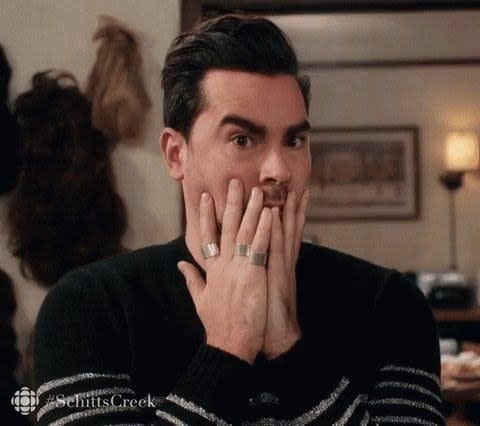 David from "Schitt's Creek" covering his mouth in surprise