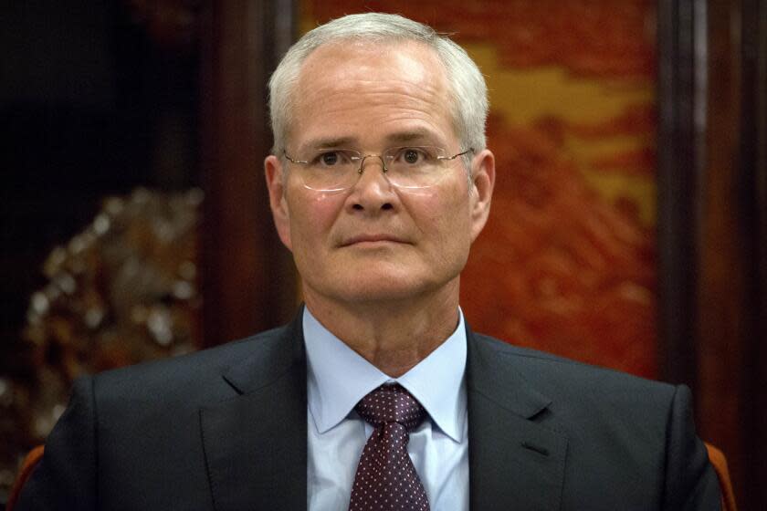 Exxon Mobil Chairman & CEO Darren Woods listens during a meeting with Chinese Premier Li Keqiang, not shown, at the Zhongnanhai Leadership Compound in Beijing, Friday, Sept. 7, 2018. (AP Photo/Mark Schiefelbein, Pool)