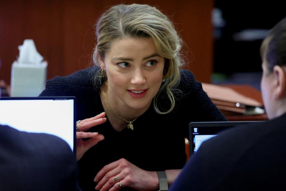 Amber Heard speaks to her legal team during her ex-husband Johnny Depp's defamation trial against her, at the Fairfax County Circuit Courthouse in Fairfax, Virginia, US on 28 April (Reuters)