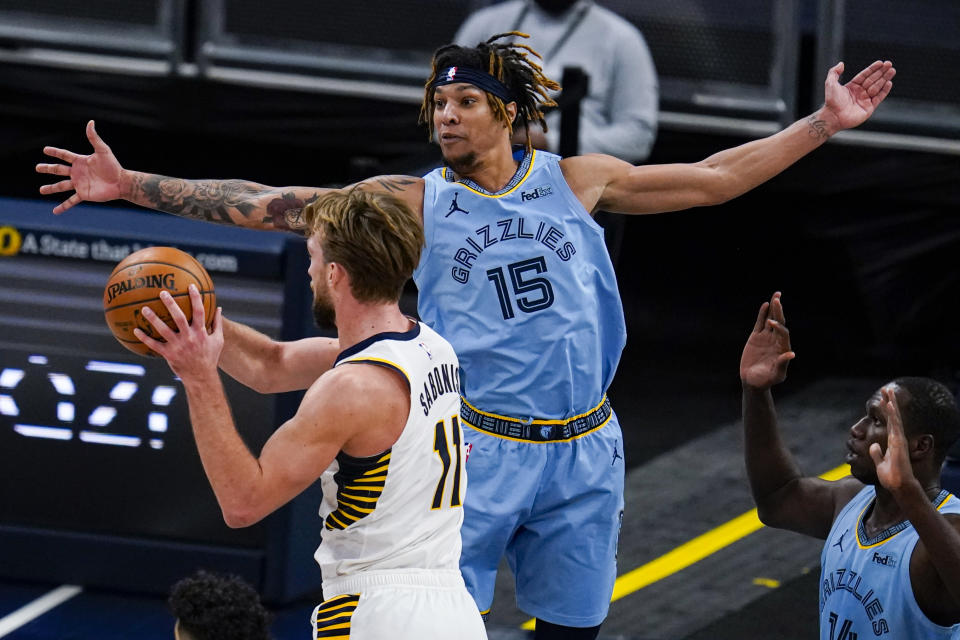 Memphis Grizzlies forward Brandon Clarke (15) defends against Indiana Pacers forward Domantas Sabonis (11) during the first half of an NBA basketball game in Indianapolis, Tuesday, Feb. 2, 2021. (AP Photo/Michael Conroy)