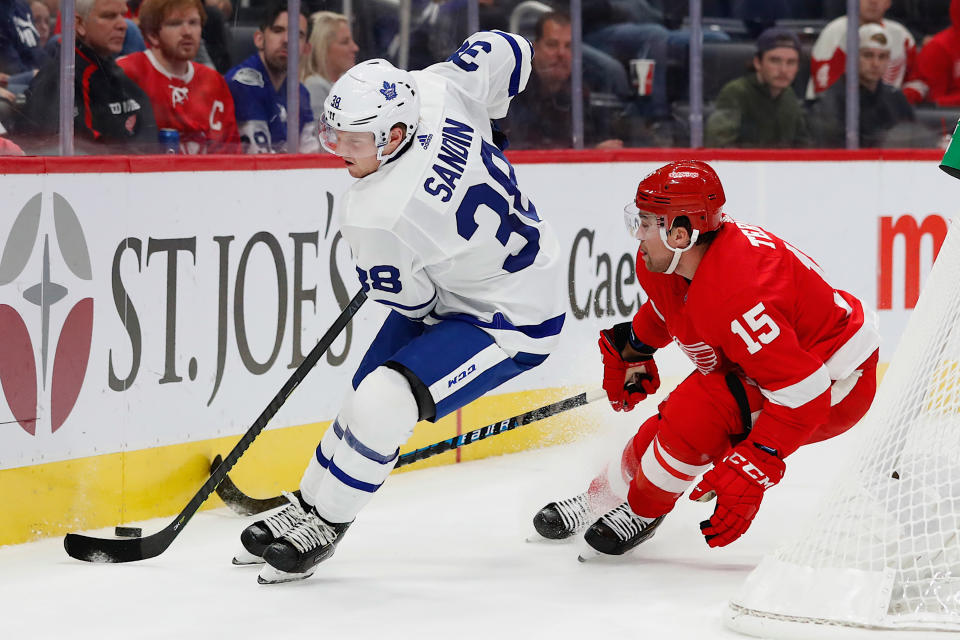 Sep 27, 2019; Detroit, MI, USA; Toronto Maple Leafs defenseman Erasmus Sandin (38) skates with the puck defended by Detroit Red Wings left wing Chris Terry (15) in the second period at Little Caesars Arena. Mandatory Credit: Rick Osentoski-USA TODAY Sports