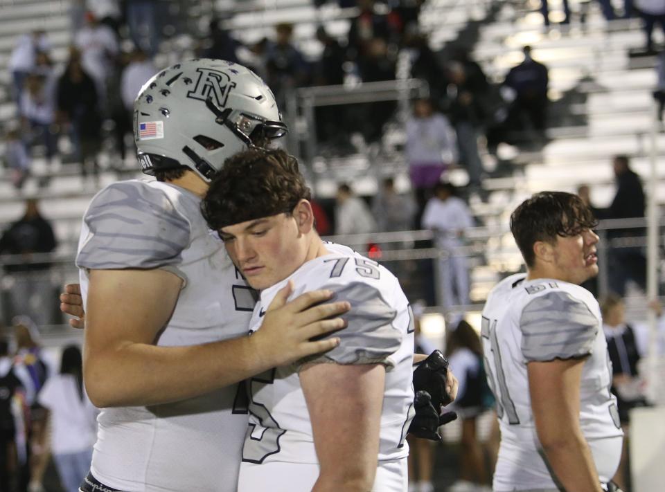 Pickerington North's Jonas Mann and Ethan Mallory share a hug following their 28-20 loss to Pickerington Central in a Division I regional quarterfinal Nov. 4.