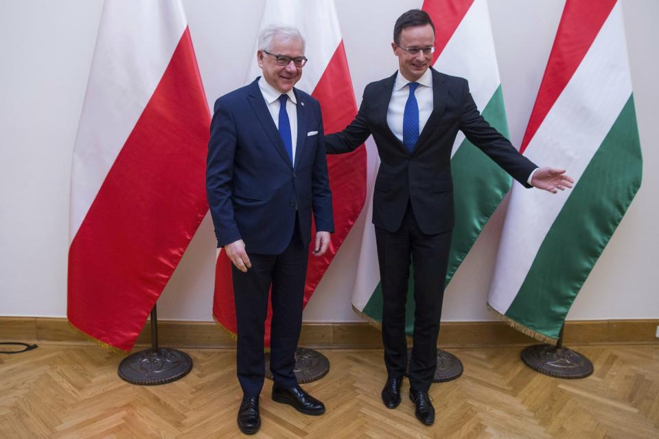 Hungarian Minister of Foreign Affairs and Trade Peter Szijjarto, right, receives Polish Minister of Foreign Affairs Jacek Czaputowicz at the Minister of Foreign Affairs and Trade in Budapest, Hungary, Wednesday, Feb. 27, 2019. (Zoltan Balogh/MTi via AP)