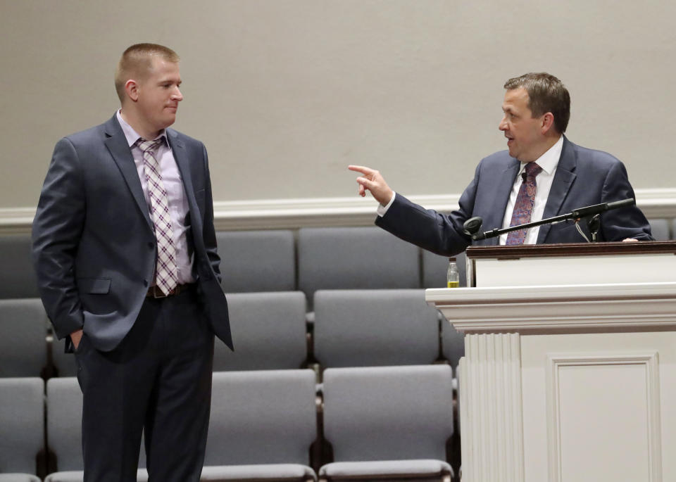 The Rev. Jimmy Toney, right, honors first responder Thomas Stanfield, an Alachua County law enforcement officer, left, during the "Night of Hope and Healing" held to honor five Louisiana Sunday school children during a church service at the Pentecostals of Gainesville church in Gainesville, Fla., Sunday, Jan. 6, 2019. The children from the Avoyelles House of Mercy in Marksville, La., were killed in a fiery wreck several days earlier and were traveling in a van on Interstate 75 when the accident happened in Alachua County, just north of Gainesville, according to the Florida Highway Patrol. (Bruce Ackerman/The Gainesville Sun via AP)