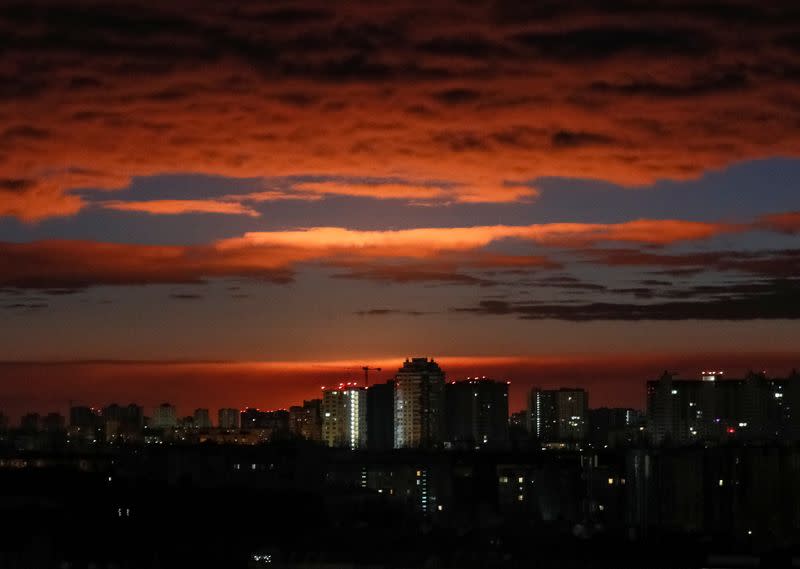 FILE PHOTO: A glow rises over skyline during a shelling in Kyiv