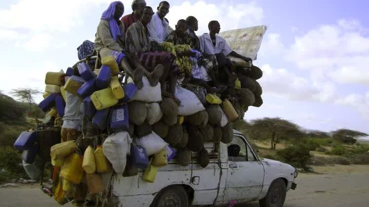 An overloaded ute drives through Mogadishu. Photo: Reuters