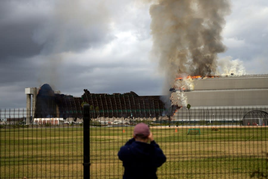 A historic blimp hangar burns in Tustin, Calif., Tuesday, Nov. 7, 2023. A fire destroyed a massive World War II-era wooden hangar that was built to house military blimps based in Southern California. (AP Photo/Jae C. Hong)