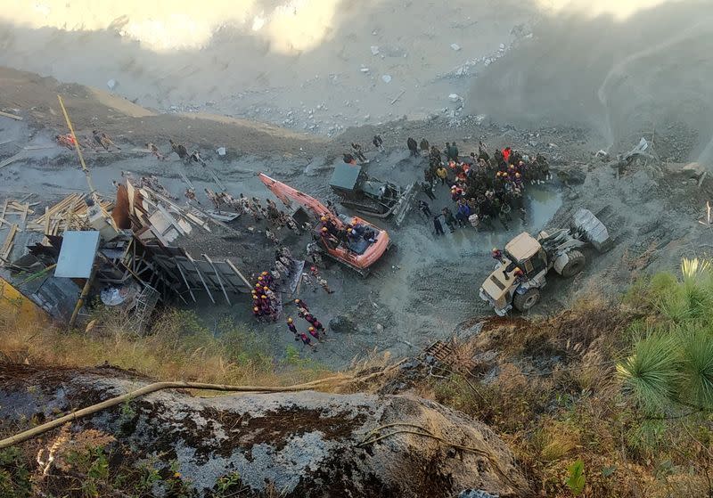 Rescue team members work near a tunnel after a part of a glacier broke away and caused flood in Tapovan