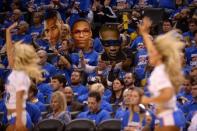 Apr 16, 2016; Oklahoma City, OK, USA; Fans hold up images of Oklahoma City Thunder guard Russell Westbrook (0) in game one of their first round NBA Playoffs series at Chesapeake Energy Arena. Mandatory Credit: Mark D. Smith-USA TODAY Sports