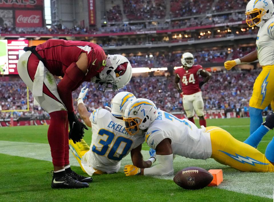 Nov 27, 2022; Glendale, AZ, USA;  Arizona Cardinals linebacker Isaiah Simmons (9) lowers his head after San Diego Chargers running back Austin Ekeler (30) scored a touchdown during the fourth quarter at State Farm Stadium. Mandatory Credit: Michael Chow-USA TODAY Sports