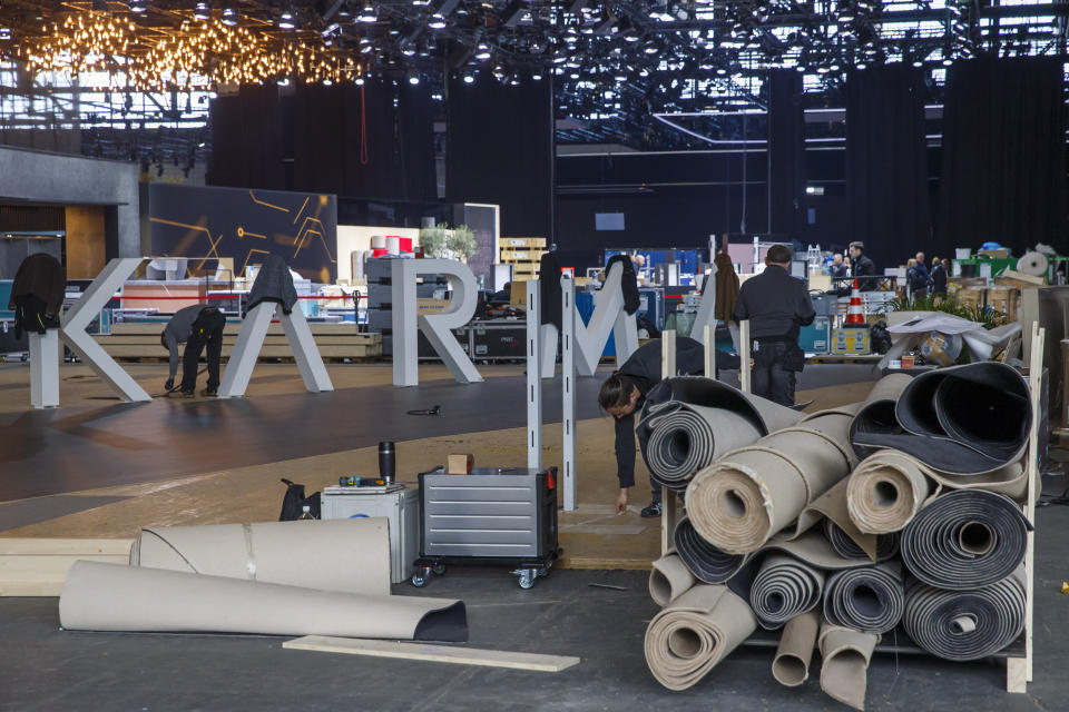 Workers dismantle a booth after that the 90th Geneva International Motor Show (GIMS) is cancelled by Swiss authorities, at the Palexpo in Geneva, Switzerland, Friday, Feb. 28, 2020. The 90th edition of the International Motor Show, scheduled to begin on March 5th, is cancelled due to the advancement of the (Covid-19) coronavirus in Switzerland. The Swiss confederation announced today that all events involving more than 1,000 people would be banned until 15 March. (KEYSTONE/Salvatore di Nolfi)