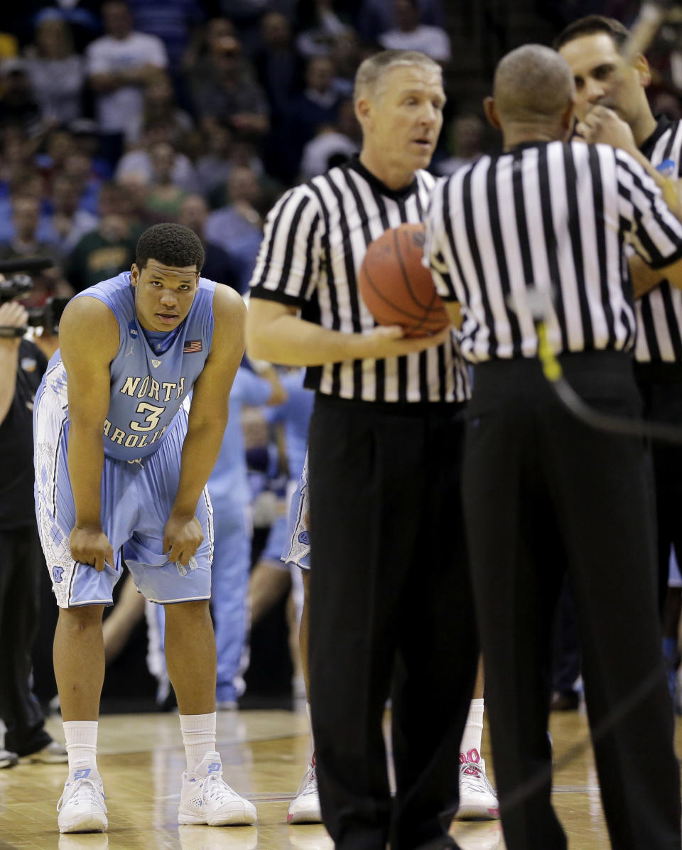 North Carolina's Kennedy Meeks (3) watches as officials discuss time remaining in the game during the closing seconds of the second half of a third-round game against Iowa State in the NCAA college basketball tournament Sunday, March 23, 2014, in San Antonio. The officials determined no time was left in the game after Iowa States' DeAndre Kane made the game-winning basket. Iowa State won 85-83. (AP Photo/David J. Phillip)