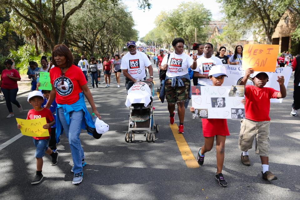 Community leaders and residents march on E. University Avenue in honor of Dr. Martin Luther King Jr., during the King Celebration 2017 National Holiday Kick-Off event. Rob C. Witzel / The Gainesville Sun
(Credit: Rob Witzel, The Gainesville Sun)