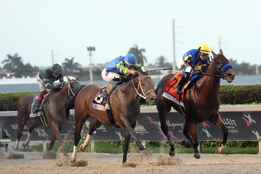 National Treasure, right, ridden by jockey Flavien Prat, beats out Senor Buscador, center.