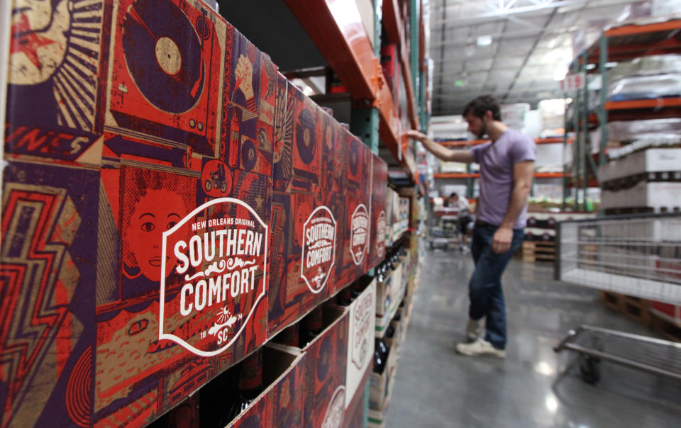 A customer looks at liquor at a Costco warehouse store Friday, June 1, 2012, in Seattle. Private retailers begin selling spirits for the first time under a voter-approved initiative kicking the state out of the liquor business. The initiative allows stores larger than 10,000 square feet and some smaller stores to sell hard alcohol.(AP Photo/Elaine Thompson)