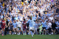 Manchester City's Jeremy Doku celebrates at the end of the English Premier League soccer match between Manchester City and West Ham United at the Etihad Stadium in Manchester, England, Sunday, May 19, 2024. Manchester City clinched the English Premier League on Sunday after beating West Ham in their last match of the season. (AP Photo/Dave Thompson)