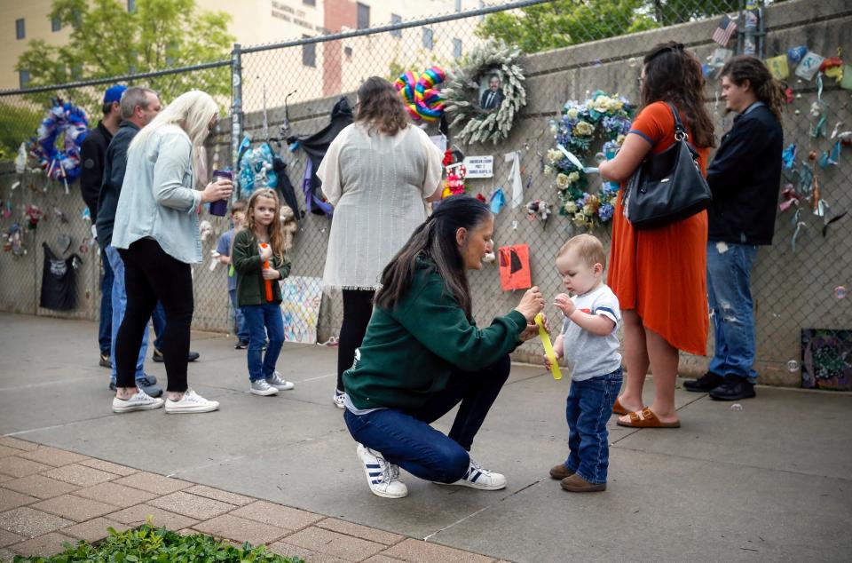 People gather at the fence outside of the Oklahoma City National Memorial and Museum on the 25th anniversary of the bombing of the Alfred P. Murrah Federal Building on April 19, 2020.