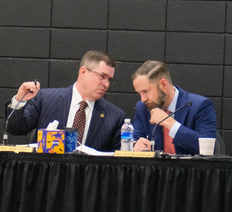 State Rep. Ken King, R-Canadian, and Rep. Dustin Burrows, R-Lubbock, confer Tuesday on the first day of the Panhandle Wildfire Investigative Committee hearing in Pampa.