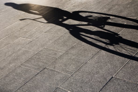 Shadow of a person riding a bike