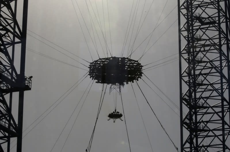 A lander is hanged for a hovering-and-obstacle avoidance test for China's Mars mission at a test facility in Huailai