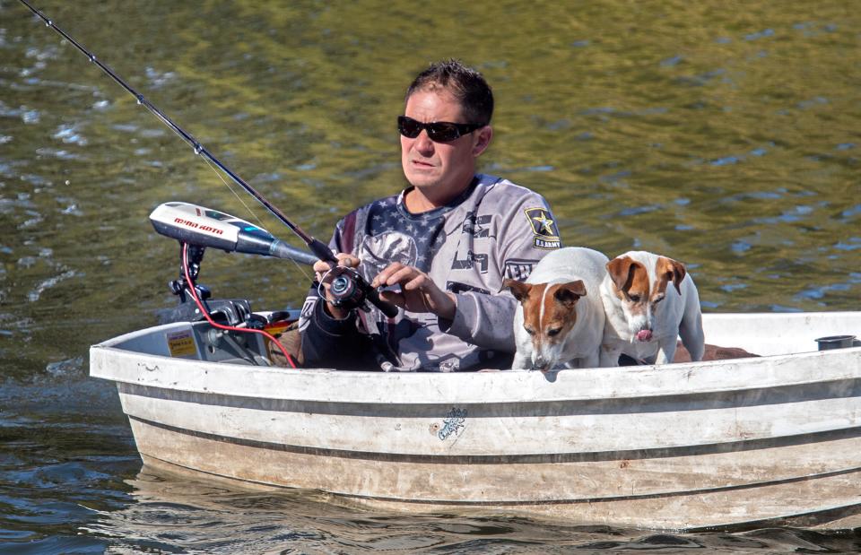 Scott Marquez of Stockton spends a relaxing afternoon fishing from his small boat with his Jack Russell terriers Oliver and Molly on Smith Canal Feb. 24 in Stockton.