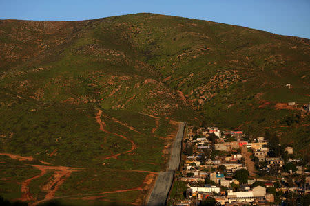 The Mexican neighborhood Nido de Aguilas is seen next to the border fence separating Mexico and the United States, on the outskirts of Tijuana, Mexico. REUTERS/Edgard Garrido