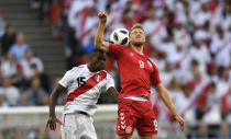 <p>Keep your eye on the ball! Peru’s Christian Ramos, left, heads for the ball with Denmark’s Nicolai Jorgensen.(AP) </p>