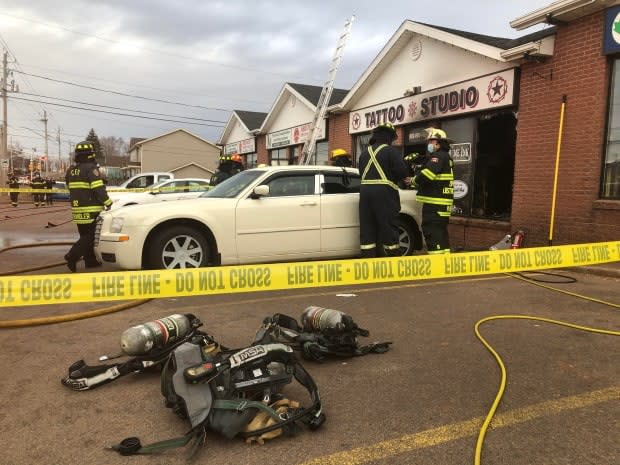 Police tape surrounds the scene of a Thursday morning fire at a Kensington Road strip mall in Charlottetown.  (Wayne Thibodeau/CBC - image credit)