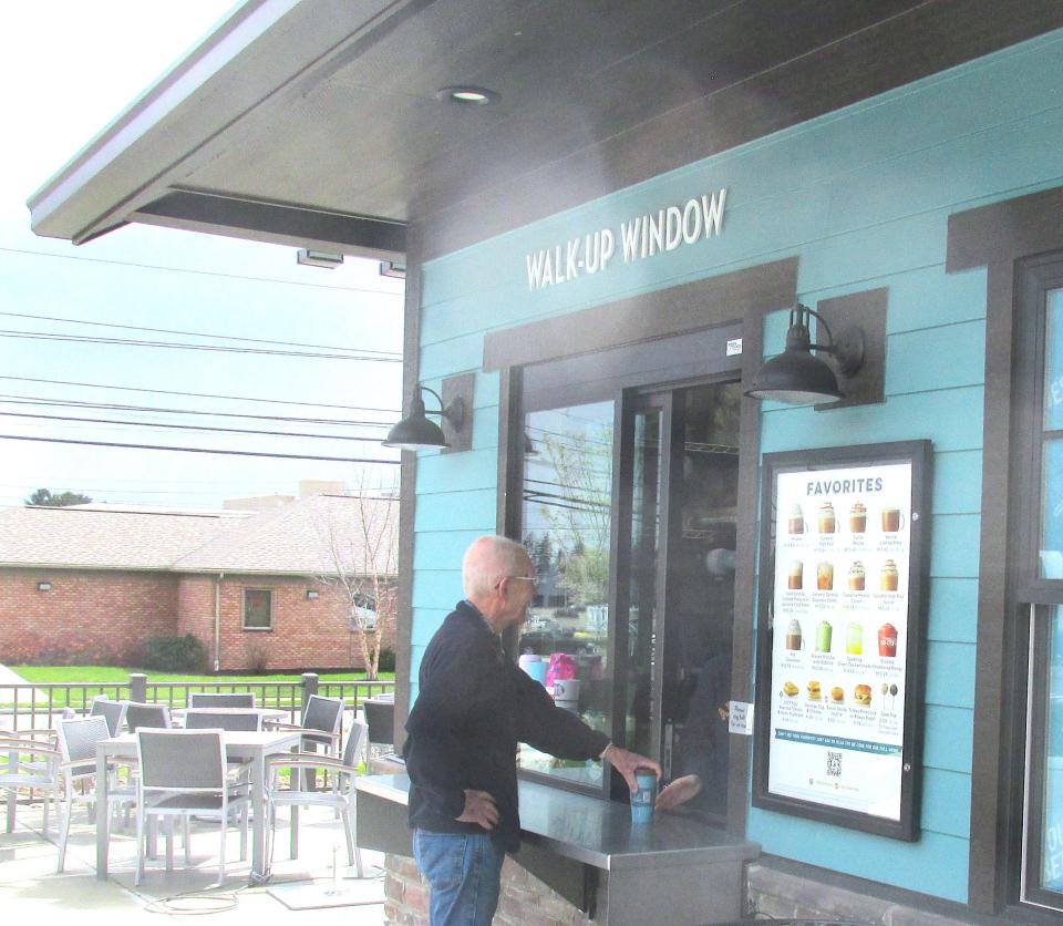 Mike Edgington of Wooster uses the walk up window to get a cup of coffee at Caribou Coffee in Wooster. It is open daily 5 a.m.-10 p.m.