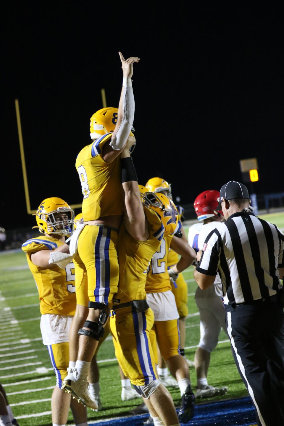 Clyde's Abe Morrison gets a lift after scoring a touchdown.