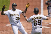 Pittsburgh Pirates' Gregory Polanco (25) celebrates with John Nogowski after both scored on an infield hit by Kevin Newman and a fielding error during the first inning of a baseball game against the New York Mets in Pittsburgh, Sunday, July 18, 2021. Three runs scored on the play. (AP Photo/Gene J. Puskar)