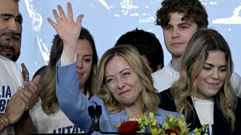 Italy's Prime Minister, Giorgia Meloni stands on stage surrounded by young people after her speech during the campaign meeting of the far-right party Fratelli d'Italia (Brothers of Italy) ahead of the European Elections, on April 28, 2024