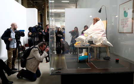 French artist Abraham Poincheval is seen in a vivarium on the first day of his performance in an attempt to incubate chicken eggs, which takes from 21 to 26 days, at the Palais de Tokyo Museum in Paris, France, March 29, 2017. REUTERS/Gonzalo Fuentes