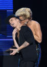 Justin Bieber is smothered in kisses by presenter Jenny McCarthy as he accepts the award for favorite album - pop/rock for “Believe” at the 40th Anniversary American Music Awards on Sunday, Nov. 18, 2012, in Los Angeles. (Photo by John Shearer/Invision/AP)