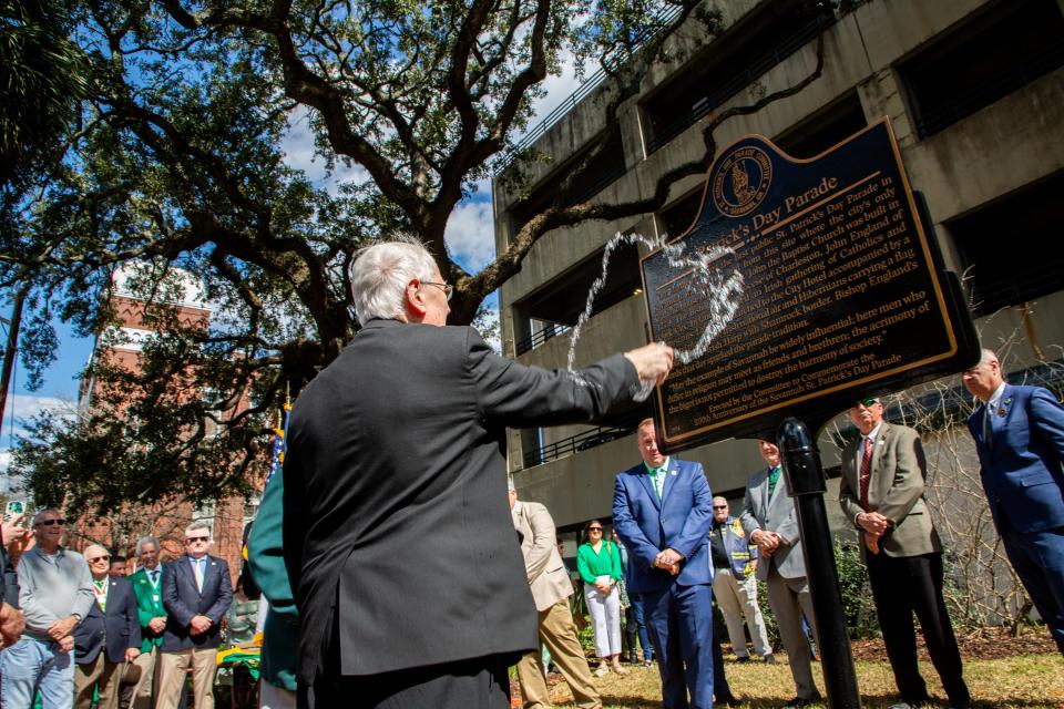 Bishop Kevin Boland blesses the Saint Patrick's Day plaque with holy water, on Saturday, February 24, 2024, in Savannah, GA.
