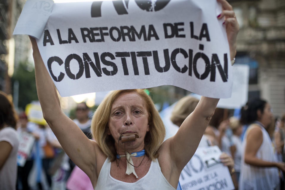 A protester carries a sign that reads in Spanish "No to constitutional reform" during anti-government demonstration in Buenos Aires, Argentina, Thursday, Nov. 8, 2012. Thousands of people marched against rising inflation, crime, exchange controls and to express their fear to a constitutional reform that could open the way for a third consecutive reelection of Argentina's President Cristina Fernandez. (AP Photo/Victor R. Caivano)