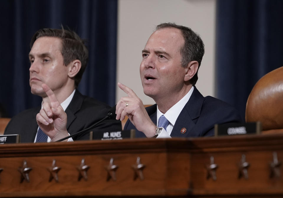 House Intelligence Committee Chairman Adam Schiff, D-Calif., with committee staffer Daniel Noble at left, makes impassioned remarks at the conclusion of a week of public impeachment hearings on President Donald Trump's efforts to tie U.S. aid for Ukraine to investigations of his political opponents, on Capitol Hill in Washington, Thursday, Nov. 21, 2019. Former White House national security aide Fiona Hill, and David Holmes, a U.S. diplomat in Ukraine, were the final witnesses today. (AP Photo/J. Scott Applewhite)