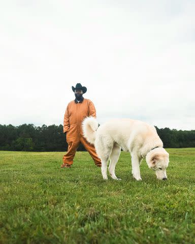 <p>Rick Ross/ Instagram</p> Rick Ross and his dog on the farm