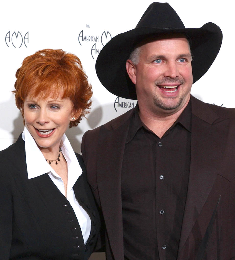 Garth Brooks and Reba McEntire  (AFP via Getty Images)